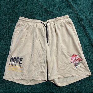 Men’s yellow shorts with mushroom/saying